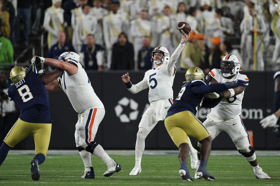 Virginia quarterback Brennan Armstrong (5) throws a pass during the first half of the team's NCAA college football game against Georgia Tech on Thursday, Oct. 20, 2022, in Atlanta. (AP Photo/John Bazemore)