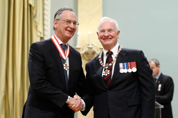 Retired Supreme Court of Canada justice Ian Binnie (L) shakes hands with Governor General David Johnston after being awarded the rank of Companion in the Order of Canada at Rideau Hall in Ottawa on November 23, 2012.