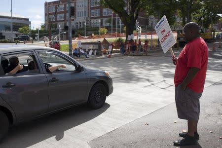 Joseph Bland, a teacher's assistant at the school, stands in solidarity as teachers strike outside Garfield High School in Seattle, Washington September 9, 2015. REUTERS/Matt Mills McKnight