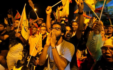 Supporters of Maldives' opposition presidential candidate Ibrahim Mohamed Solih celebrate their victory in Male - Credit: Eranga Jayawardena/AP