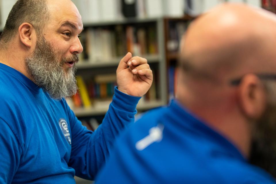 Quiz Bowl team co-head coach Ben Herman talks to team members next to co-head coach Christopher Gismondi during practice at Detroit Catholic Central High School in Novi on Wednesday, May 24, 2023.