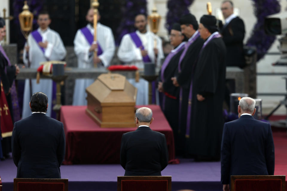 Lebanese Prime Minister Saad Hariri, left, President Michel Aoun, center, and House Speaker Nabih Berri, stand in front of the coffin of former Maronite Patriarch Cardinal Mar Nasrallah Boutros Sfeir, during his funeral, at the seat of the Maronite Church, in the village of Bkirki, north of Beirut, Lebanon, Thursday, May 16, 2019. Sfeir, who served as spiritual leader of Lebanon's largest Christian community through some of the worst days of the country's 1975-1990 civil war, died Sunday. (AP Photo/Bilal Hussein)