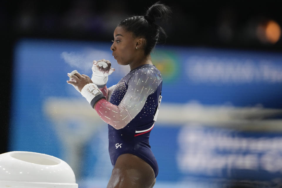 United States' Simone Biles chalks her hands prior to her uneven bar exercise during the women's team final at the Artistic Gymnastics World Championships in Antwerp, Belgium, Wednesday, Oct. 4, 2023. (AP Photo/Virginia Mayo)