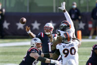 New England Patriots quarterback Cam Newton (1) passes under pressure from Denver Broncos defenders Shelby Harris, right rear, and DeShawn Williams (90) in the first half of an NFL football game, Sunday, Oct. 18, 2020, in Foxborough, Mass. (AP Photo/Steven Senne)