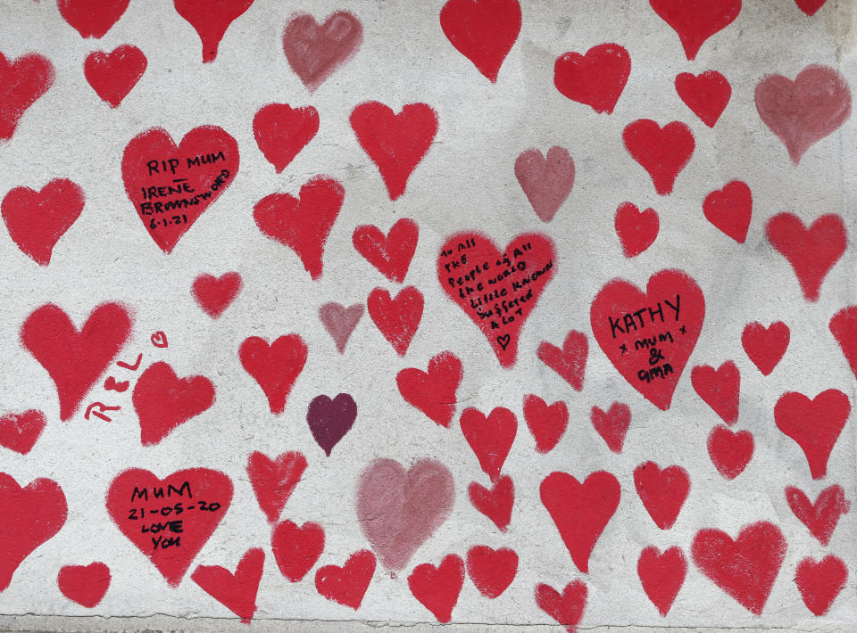 A close up of the hearts on the 'The National COVID Memorial Wall' on the south bank of the Thames in front of St. Thomas' hospital and opposite the House of Parliament in London, Sunday April 4, 2021. Hearts are being drawn onto the wall in memory of the many thousands of people who have died in the UK from coronavirus, with organizers hoping to reach their target of 150,000 hearts by the middle of next week. (AP Photo/Tony Hicks)