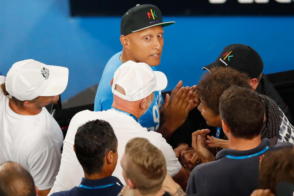 Christos Kyrgios, pictured here watching Nick from the crowd at the Australian Open in 2018.