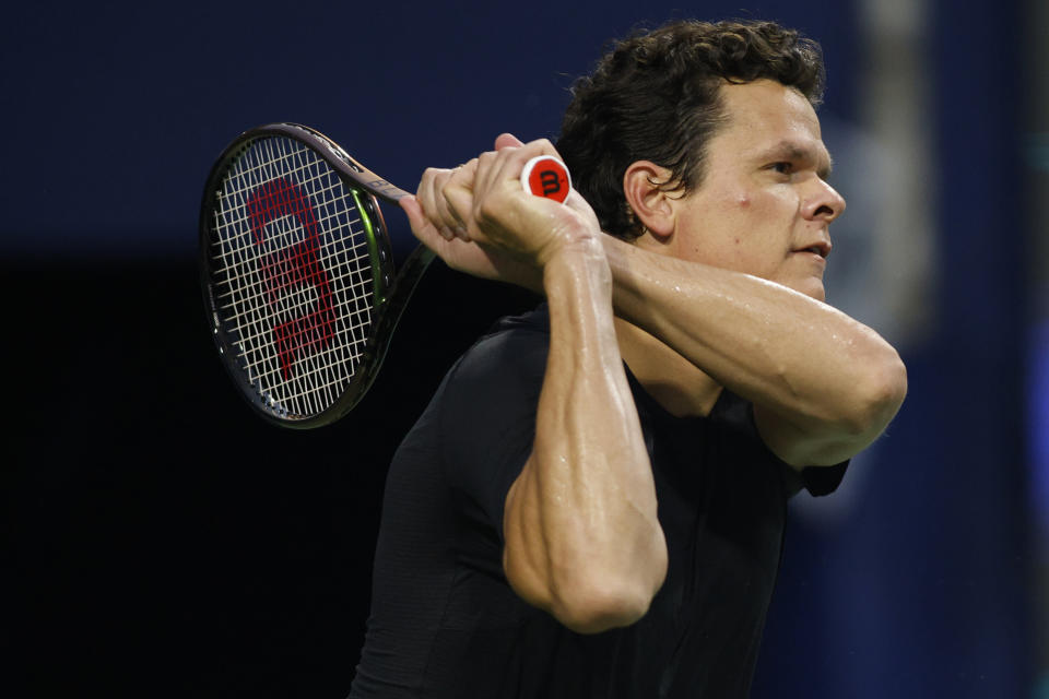 Canada's Milos Raonic plays a point back to Frances Tiafoe, of the United States, during the first day of the men's National Bank Open tennis tournament in Toronto, Monday, Aug. 7, 2023. (Cole Burston/The Canadian Press via AP)