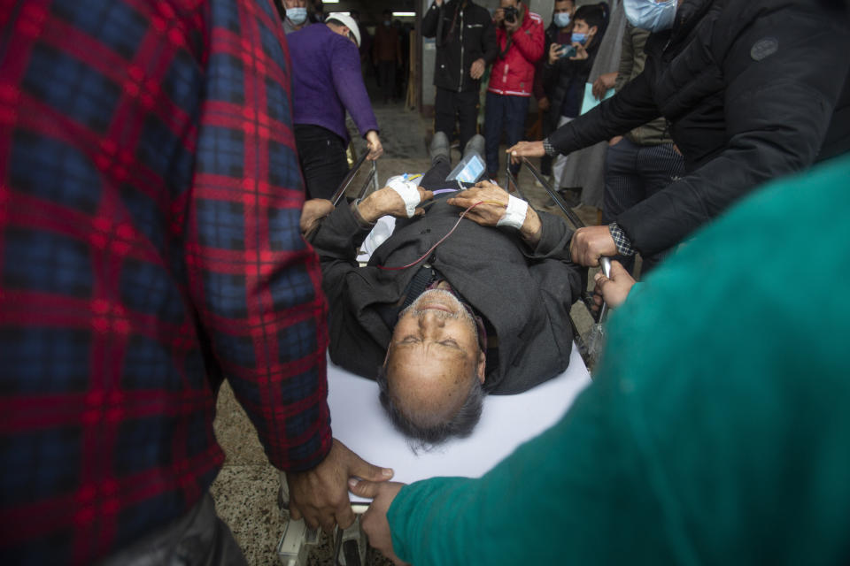 A Kashmiri man injured in an attack is brought for treatment at a hospital in Srinagar, Indian controlled Kashmir, Monday, March. 29, 2021. Gunmen killed an elected official of India’s ruling party and a policeman in disputed Kashmir on Monday, police said. (AP Photo/Mukhtar Khan)