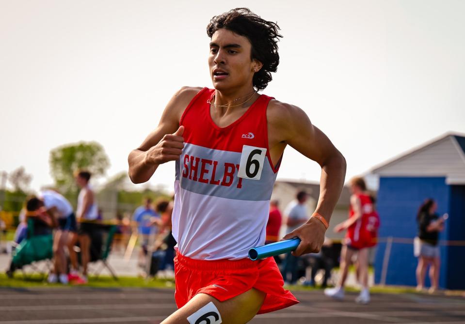 Shelby’s Luke Lesseuer runs the anchor for Shelby’s record-setting 4x800 team on Thursday night during the Division II district meet at Ontario.