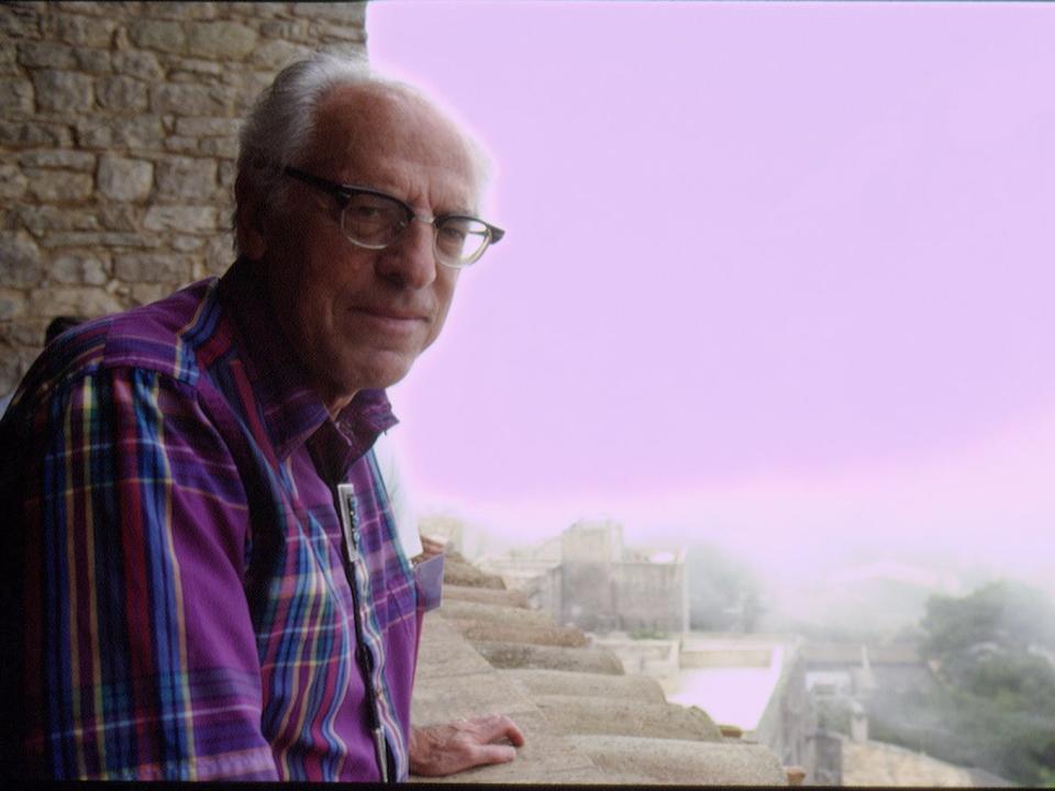 Nobel Prize Winner Frederick Reines standsi n front of a purple sunset in 2001