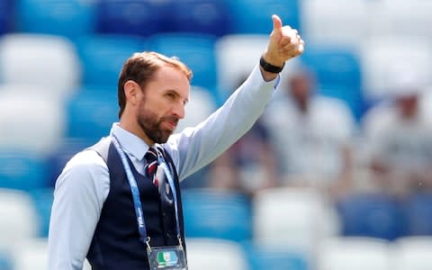Gareth Southgate acknowledges the England supporters before the game - Credit: REUTERS/Matthew Childs