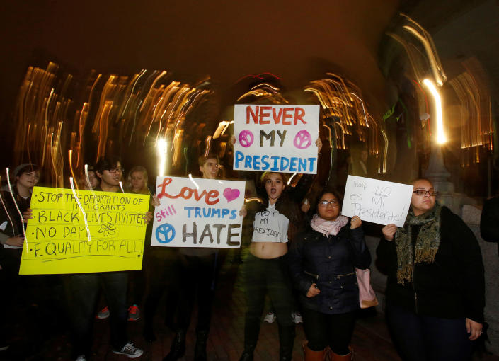 <p>Protesters hold signs in opposition to the election of Republican Donald Trump as President of the United States in Boston, Massachusetts, U.S. November 9, 2016. (REUTERS/Mary Schwalm) </p>