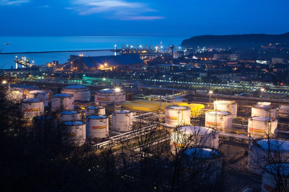 Oil storage tanks stand illuminated at night at the RN-Tuapsinsky refinery, operated by Rosneft Oil Co., in Tuapse, Russia, on Sunday, March 22, 2020. (Andrey Rudakov/Bloomberg via Getty Images)