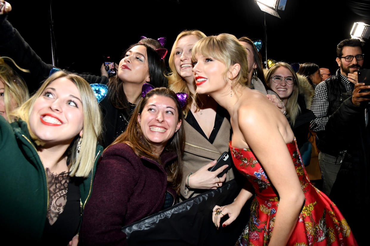 NEW YORK, NEW YORK - DECEMBER 16: Taylor Swift is seen with fans during The World Premiere of Cats, presented by Universal Pictures on December 16, 2019 in New York City. (Photo by Kevin Mazur/Getty Images  for Universal Pictures)