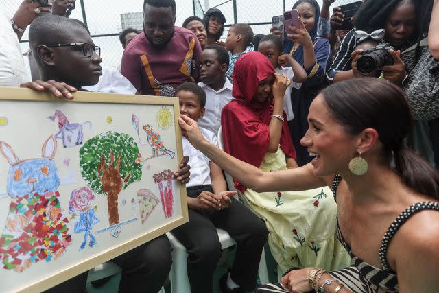 <p>KOLA SULAIMON/AFP via Getty</p> Meghan Markle greets young fans at an exhibition sitting volleyball match at Nigeria Unconquered, a local charity organisation that supports wounded, injured, or sick servicemembers, in Abuja on May 11, 2024