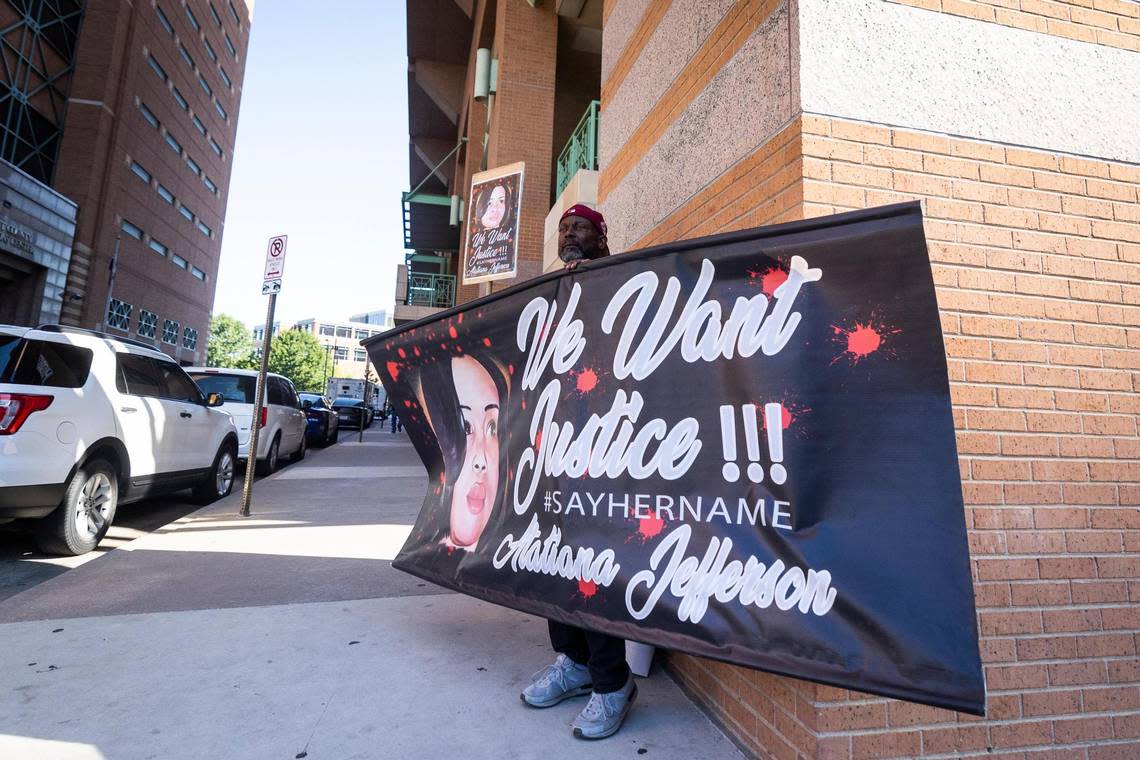 James Smith holds up a sign for Atatiana Jefferson as a recusal hearing is happening on Judge David Hagerman’s status in the Aaron Dean case on June 23, 2022, in Fort Worth.