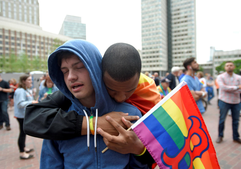 Chris Bartley (front) is hugged by Sam Johnson at a vigil for the victims of the mass shooting at Orlando's Pulse nightclub in Boston, Massachusetts, U.S. June 13, 2016.&nbsp;