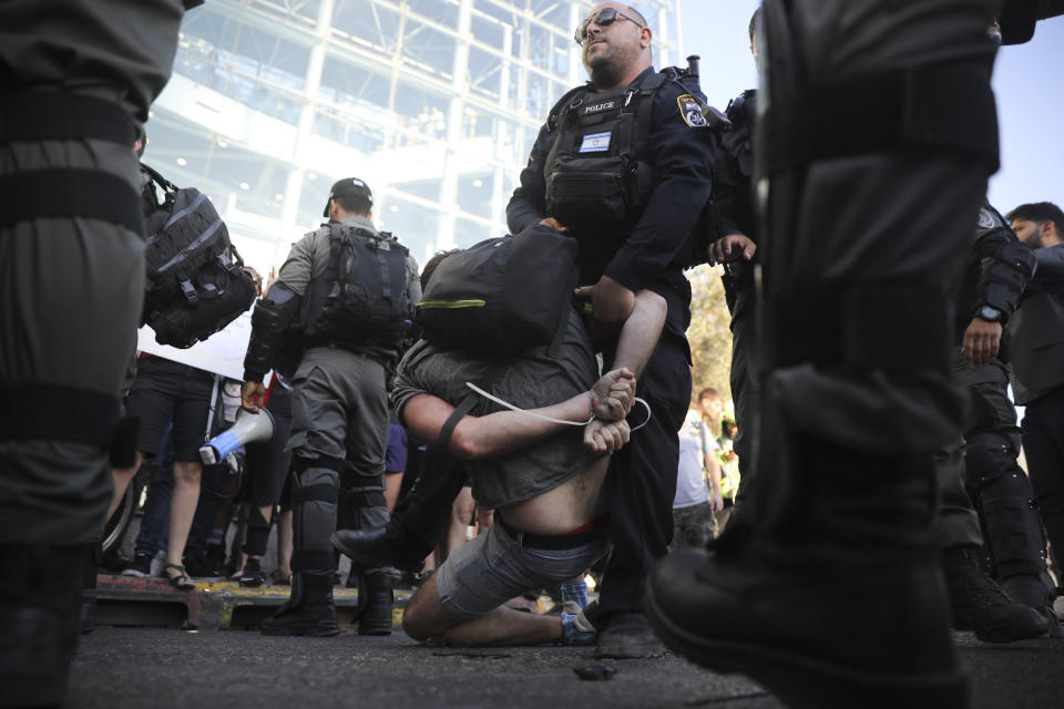 Police arrest a a man during a protest in Tel Aviv, Israel, Wednesday, July 3, 2019. Israeli police were bracing for another day of violent protests Wednesday after community activists called for renewed street demonstrations in response to the killing of an Ethiopian-Israeli teen by an off-duty police officer. (AP Photo/Oded Balilty)