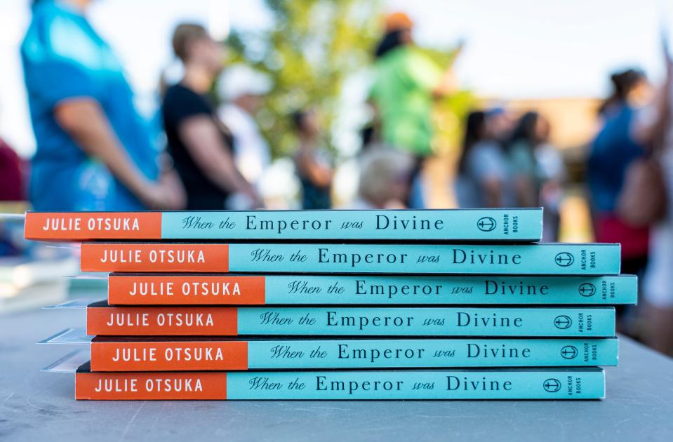 The Asian American and Pacific Islander Coalition and community members gave out 100 copies of Julie Otsuka's novel "When the Emperor was Divine" at the Community Teach-in outside of the Educational Services Center Building in Muskego.