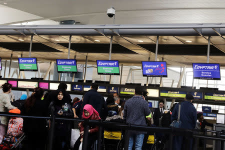 Travelers wait to check in at an Egypt Air counter at JFK International Airport in New York, U.S., March 21, 2017. REUTERS/Lucas Jackson