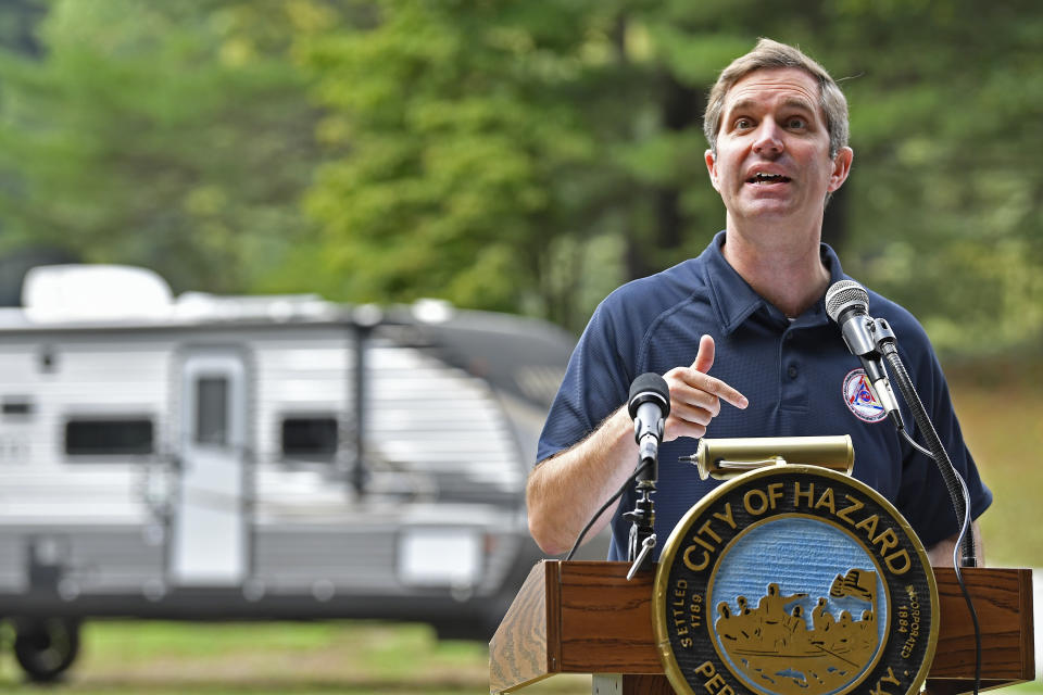 Kentucky Governor Andy Beshear stands in front of one of the travel trailers that have arrived from Louisiana in Hazard, Ky., Tuesday, Sept. 6, 2022. The trailers are to be used as temporary housing for families that had been displaced by the floodwaters in late July. (AP Photo/Timothy D. Easley)