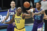 Charlotte Hornets forward P.J. Washington (25) passes the ball away from Indiana Pacers center Myles Turner (33) during the first half of an NBA basketball game in Charlotte, N.C., Wednesday, Jan. 27, 2021. (AP Photo/Nell Redmond)