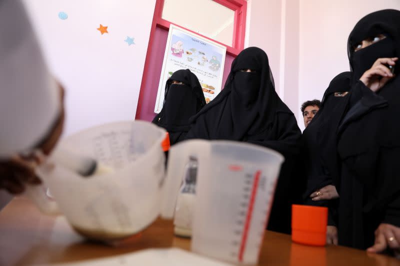 Women wait to receive supplemental nutrition shakes, at malnutrition treatment ward of al-Sabeen hospital in Sanaa