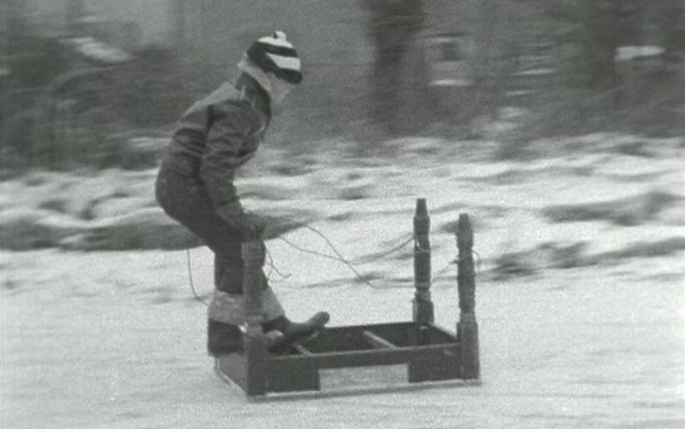 Kid sledding on an upside down table