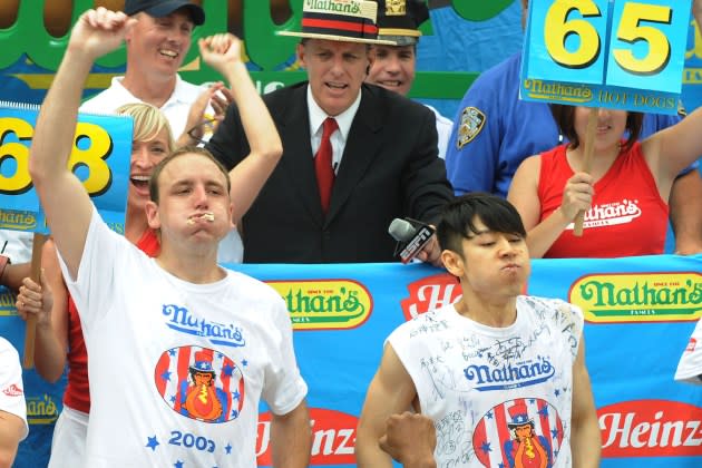 Joey Chestnut and Takeru Kobayashi at the Nathan's Hot Dog Eating Contest in 2009, the last time they competed against each other. - Credit: Bobby Bank/WireImage