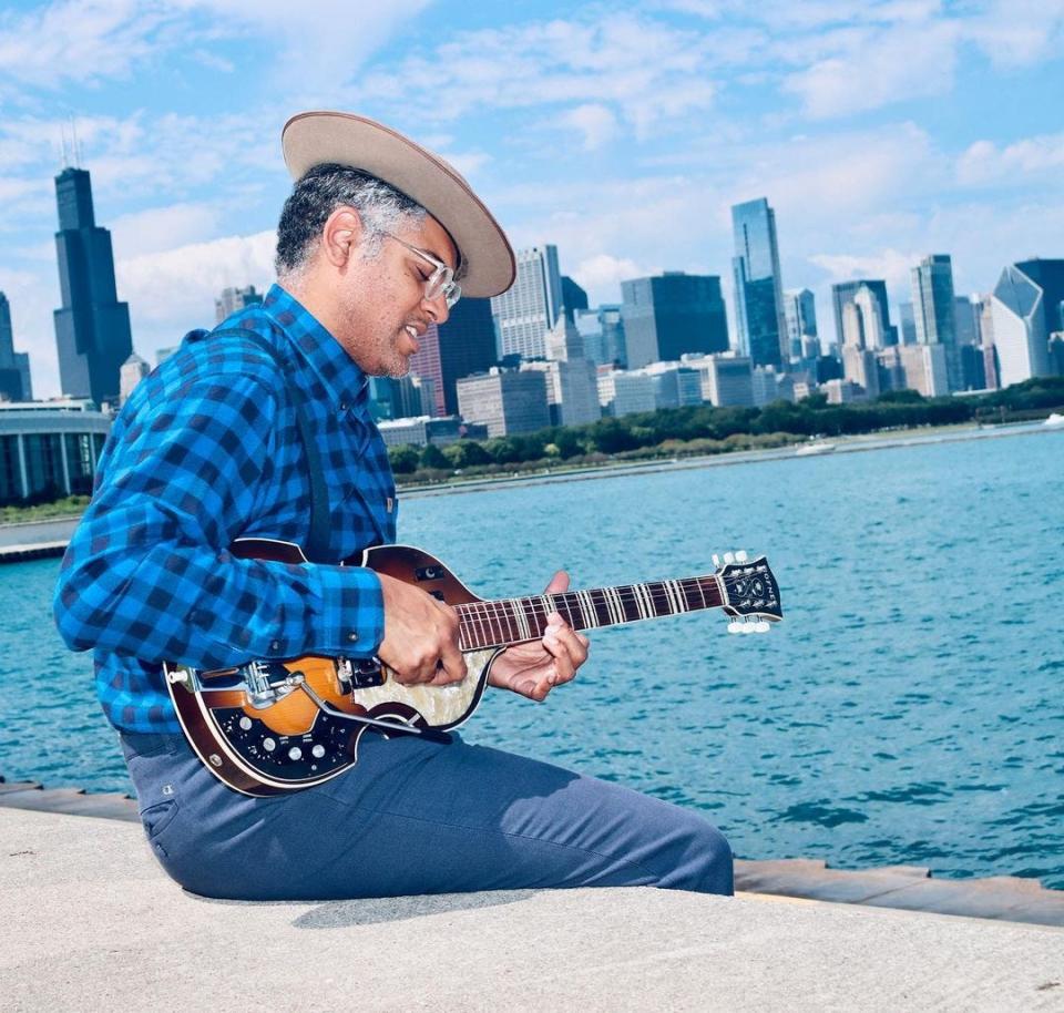 Dom Flemons plays his bass guitar in Chicago, near his current home of Naperville, Illinois.