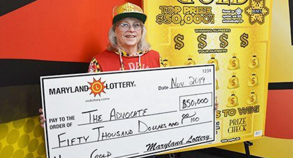 Teacher from Maryland pictured with giant USD$50,000 cheque.