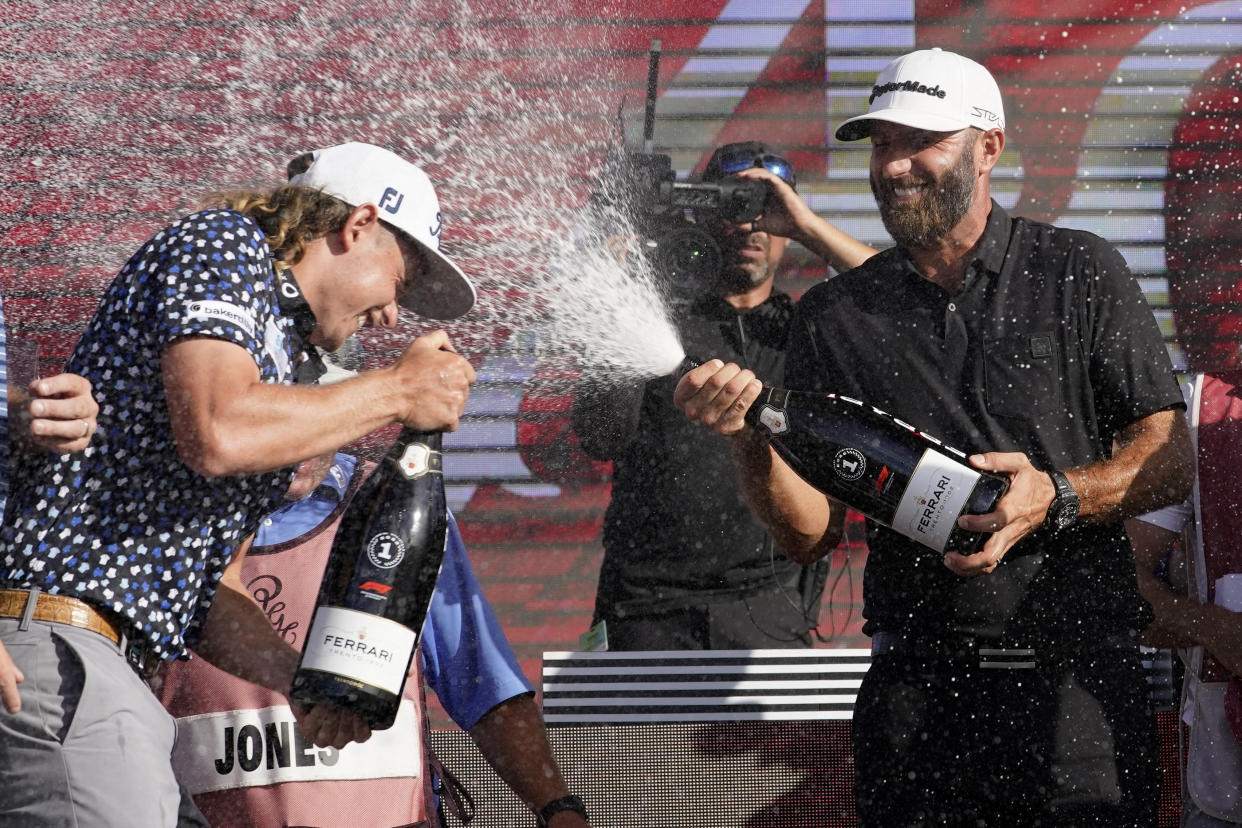 Cameron Smith, left, and Dustin Johnson, right, celebrate after the final round of the LIV Golf Team Championship at Trump National Doral Golf Club, Sunday, Oct. 30, 2022, in Doral, Fla. Johnson's 4 Aces GC team won the team championship. (AP Photo/Lynne Sladky)