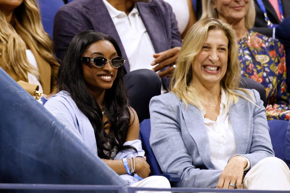 TOPSHOT - US gymnast Simone Biles (L) watches Poland's Iga Swiatek and USA's Jessica Pegula during their women's quarterfinals match on day ten of the US Open tennis tournament at the USTA Billie Jean King National Tennis Center in New York City, on September 4, 2024. (Photo by Kena Betancur / AFP) (Photo by KENA BETANCUR/AFP via Getty Images)