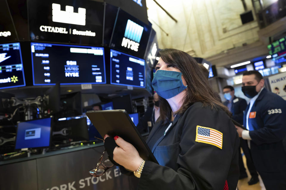 FILE - In this Wednesday March 10, 2021 photo provided by the New York Stock Exchange, trader Phyllis Arena Woods works on the trading floor. A year earlier, a terrifying free fall for the stock market suddenly ended, ushering in one of its greatest runs. (Nicole Pereira/New York Stock Exchange via AP)