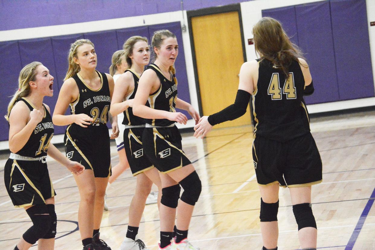 St. Ignace players react after Ally Schultz' game-winning basket was confirmed by officials in a 58-56 win over Pickford Wednesday night. Schultz (33) finished with 22 points for the Saints.