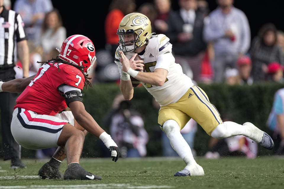 Georgia Tech quarterback Zach Gibson (15) tries to get past Georgia linebacker Marvin Jones Jr. (7) during the second half of an NCAA college football game Saturday, Nov. 26, 2022 in Athens, Ga. (AP Photo/John Bazemore)