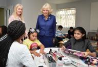 <p>The Duchess of Cornwall wore a royal blue suit that she accessorized with two broaches and pearl drop earrings for a visit to one of her royal patronages, the Barnardo's charity. </p>