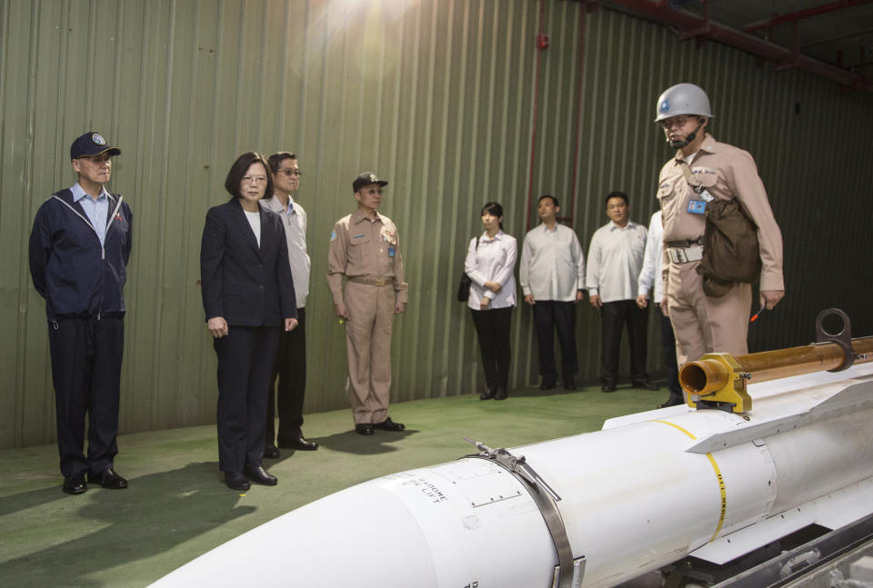 FILE - In this photo Friday, April 13, 2018, file photo, released by Military News Agency, Taiwan's President Tsai Ing-wen, second from left, listens to a brief on a missile at Su'ao naval station during a navy exercise in the northeastern port of Su'ao in Yilan County, Taiwan. Taiwan is responding to China’s defense buildup by developing missiles and interceptors of its own that could reduce Beijing’s military advantage over the island, defense experts say. (Military News Agency via AP, File)