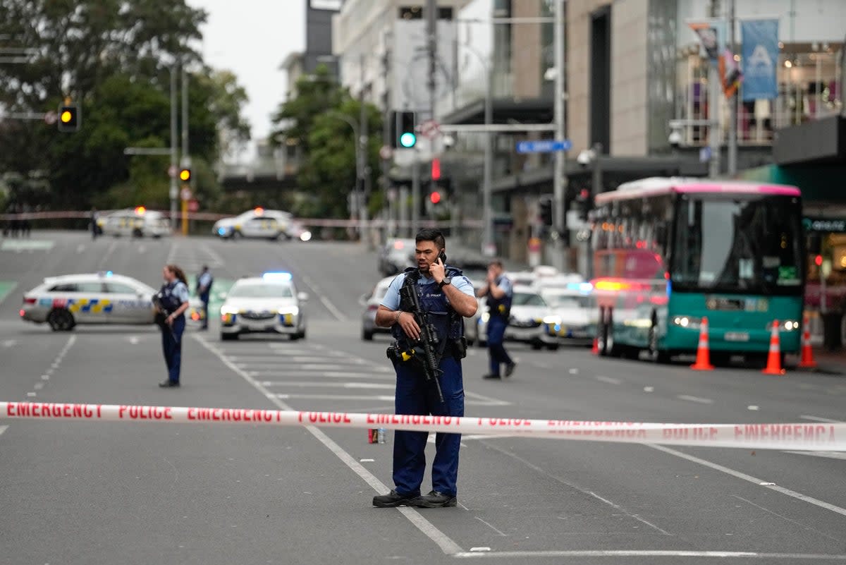 Armed New Zealand police officers stand at a road block in the central business district following a shooting in Auckland, New Zealand, Thursday, July 20, 2023 (AP)