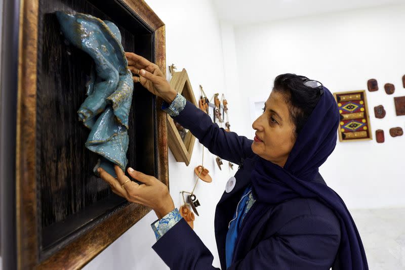 Awatif Al-Keneibit, a Saudi artist, shows her art in her studio, in Riyadh