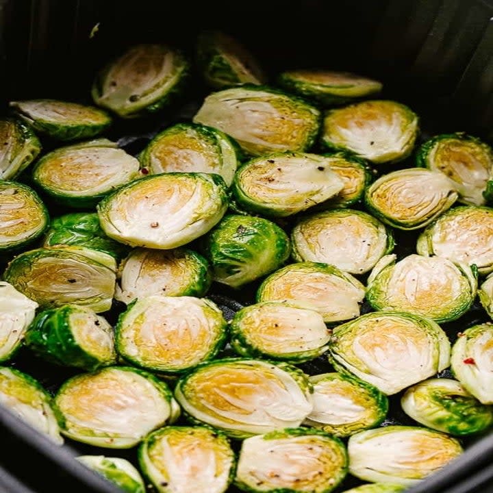 Halved Brussels sprouts in the air fryer.