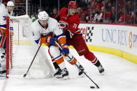 Carolina Hurricanes' Steven Lorentz (78) and New York Islanders' Adam Pelech (3) works behind the Islanders' net during the second period of an NHL hockey game in Raleigh, N.C., Thursday, Oct. 14, 2021. (AP Photo/Karl B DeBlaker)