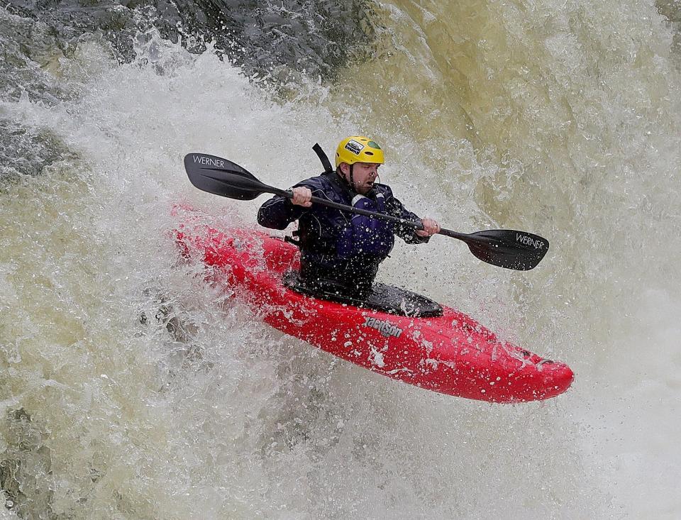 A kayaker heads over the falls during a previous Cuyahoga Falls fest on the Cuyahoga River behind the Sheraton Suites downtown.