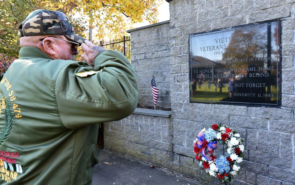Army Vietnam veteran Tommy Trott salutes after placing a wreath at the Vietnam monument on the Hyannis Village Green as part a Veterans Day ceremony on Nov. 11, 2023.