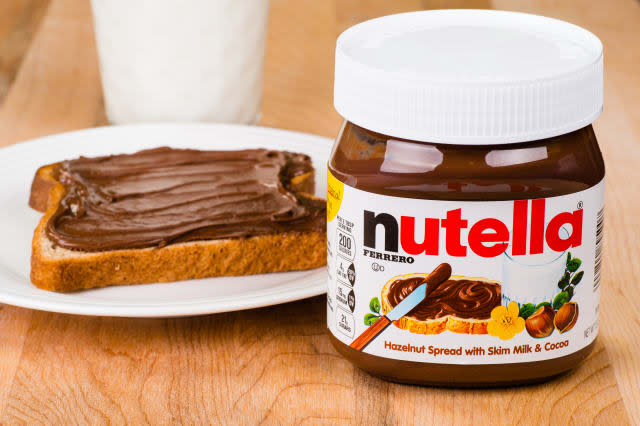 ATLANTA - APRIL 23, 2014: Jar of Nutella, toast with Nutella spread and milk to drink.