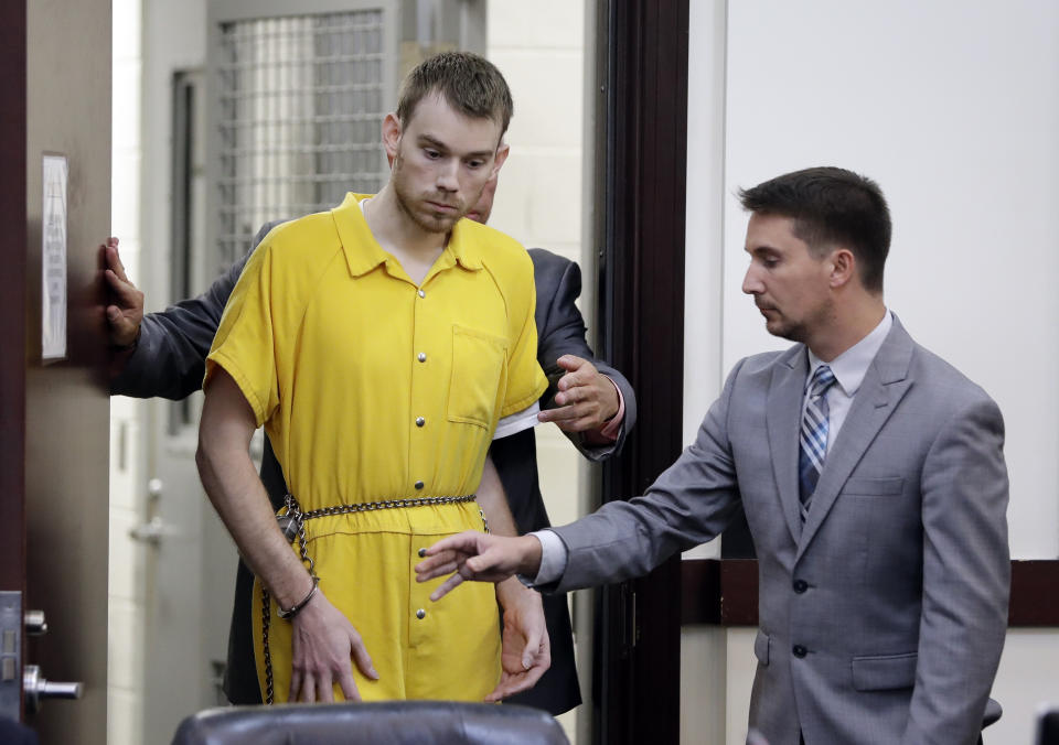 Travis Reinking, left, enters a courtroom for a hearing Wednesday, Aug. 22, 2018, in Nashville, Tenn. Reinking is charged with killing four people during a shooting at a Waffle House restaurant in Nashville in April. (AP Photo/Mark Humphrey)