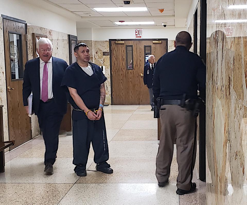Bernardo Mendez, center, is escorted Thursday out of the 137th District Court where he was sentenced to 15 years in prison after pleading guilty to murder in the 2015 beating death of 51-year-old Herbert Fetherolf.