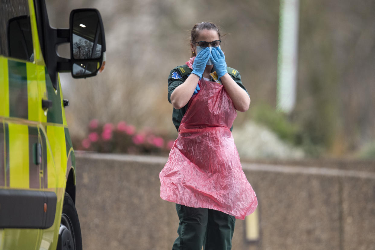 LONDON, UNITED KINGDOM - APRIL 01: A hospital worker adjust her face mask outside St Thomas' hospital on April 01, 2020 in London, England. The Coronavirus (COVID-19) pandemic has spread to many countries across the world, claiming over 40,000 lives and infecting hundreds of thousands more. (Photo by Justin Setterfield/Getty Images)