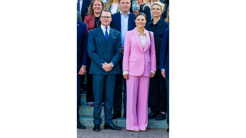 Victoria in pink suit with daniel and others