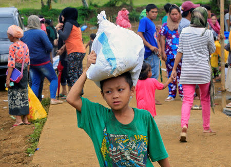 An evacuee carries relief goods, after fleeing to an evacuation centre to avoid the fighting in Marawi between the government troops and Islamic State-linked militants, in Saguiaran town, Lanao Del Sur, southern Philippines September 10, 2017. REUTERS/Romeo Ranoco